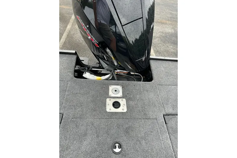 Slide: The Image of 2026 Tracker Targa V-19 Combo boat engine and deck view in a parking lot. - 6