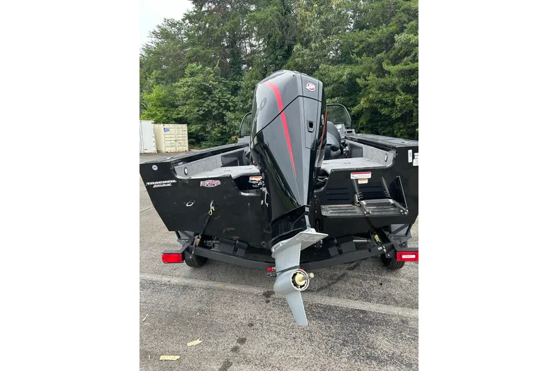 Slide: The Image of 2026 Tracker Targa V-19 Combo boat with powerful outboard motor, parked outdoors. - 3