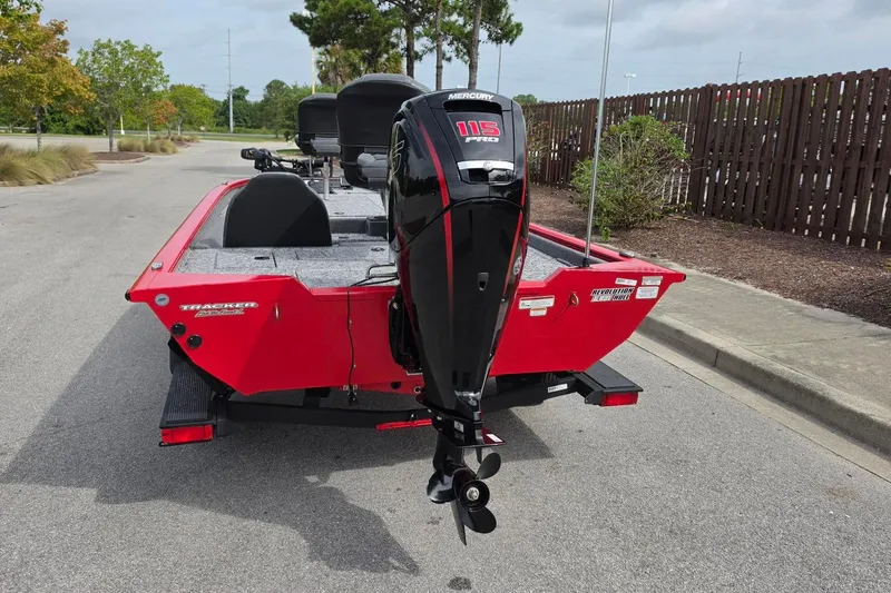 Slide: The Image of 2026 Tracker Pro Team 190 boat with Mercury 115 Pro XS engine, parked outdoors. - 12