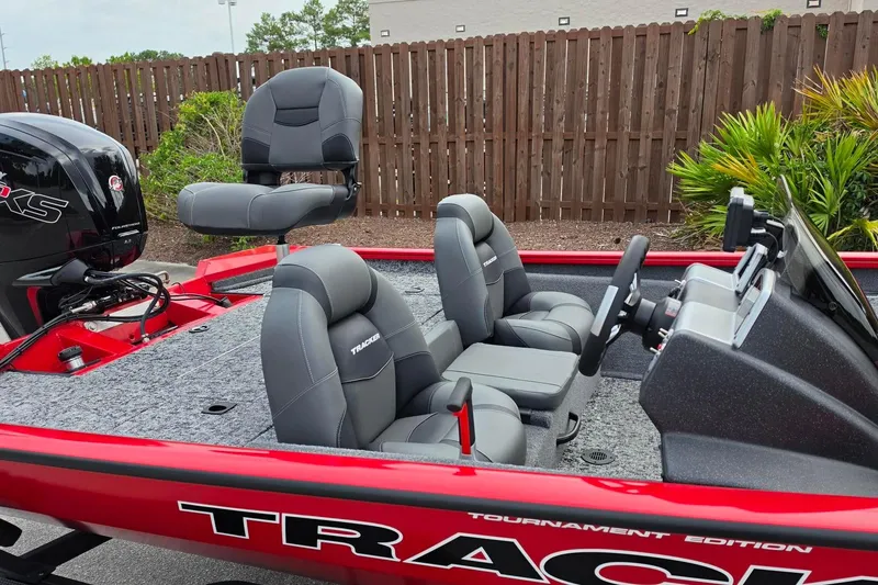 Slide: The Image of 2026 Tracker Pro Team 190 boat interior with gray seating and steering console. - 16