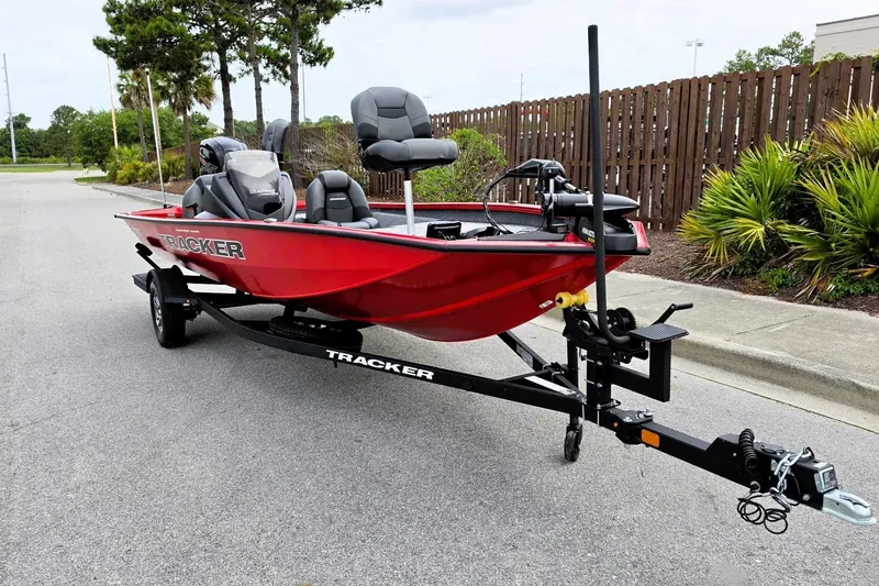 Slide: The Image of 2026 Tracker Pro Team 190 boat in vibrant red on a trailer, parked outdoors. - 5