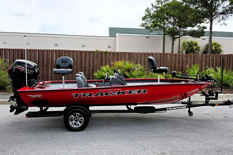 The Image of 2026 Tracker Pro Team 190 boat in vibrant red, parked on a trailer outdoors. - 0
