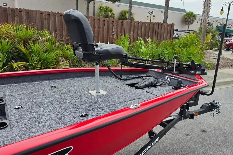 Slide: The Image of Red 2026 Tracker Pro Team 190 boat with Minn Kota trolling motor, parked outdoors. - 17