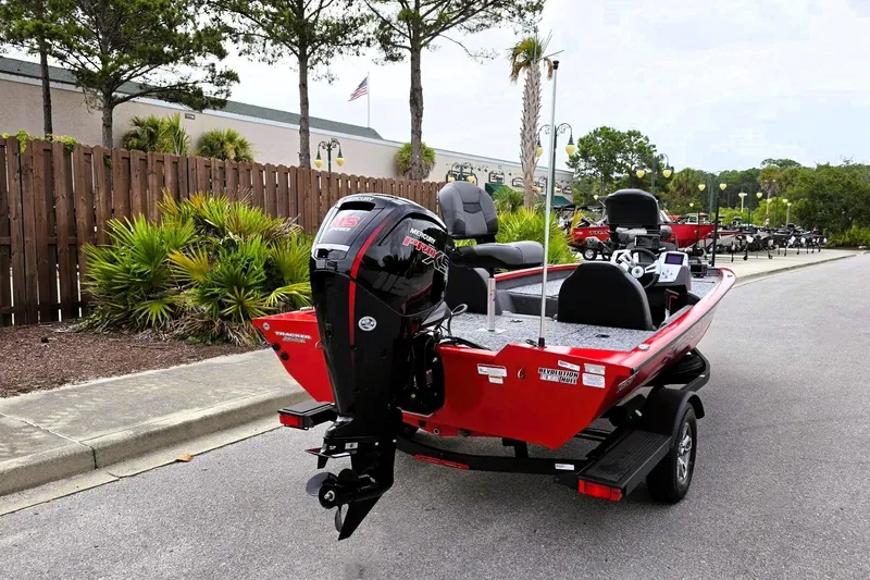 Slide: The Image of 2026 Tracker Pro Team 190 boat with Mercury engine, parked outdoors on a sunny day. - 3