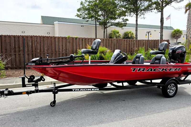 Slide: The Image of 2026 Tracker Pro Team 190 boat in vibrant red on a trailer, parked outdoors. - 10