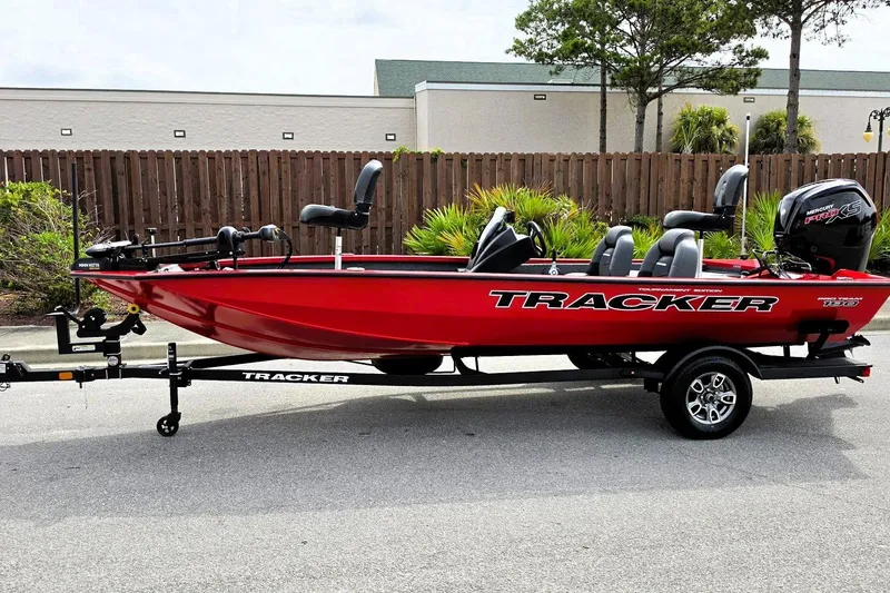 Slide: The Image of 2026 Tracker Pro Team 190 boat in vibrant red on a trailer, parked outdoors. - 9