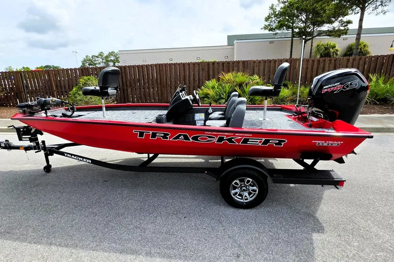 Slide: The Image of 2026 Tracker Pro Team 190 boat, red, parked on trailer, outdoor setting. - 13
