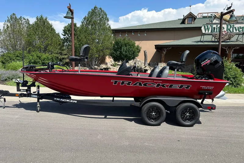 The Image of 2026 Tracker Pro Team 195 boat in vibrant red, parked outdoors on a trailer. - 0