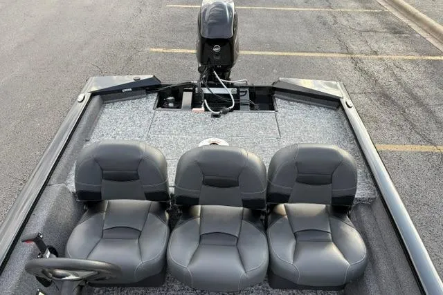 Slide: The Image of 2026 Tracker Pro Team 175 Crappie Edition boat with three gray seats and motor. - 17