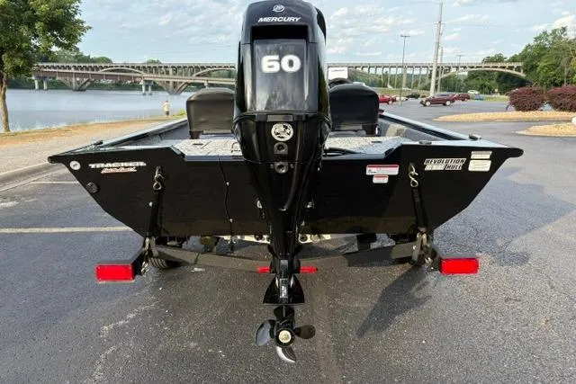 Slide: The Image of 2026 Tracker Pro Team 175 Crappie Edition boat with Mercury 60 engine, parked near a river. - 9