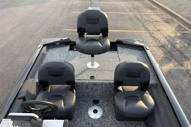 Slide: The Image of 2026 Tracker Pro Team 175 Crappie Edition boat with three seats in a parking lot. - 24
