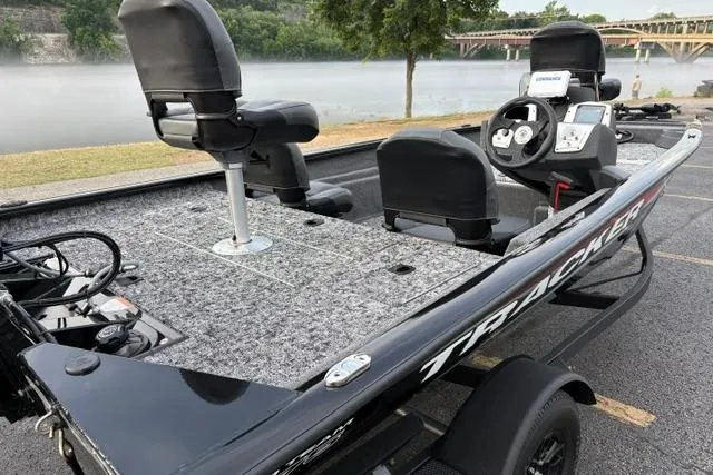 Slide: The Image of 2026 Tracker Pro Team 175 Crappie Edition boat, featuring spacious seating and advanced controls by a serene lake. - 26