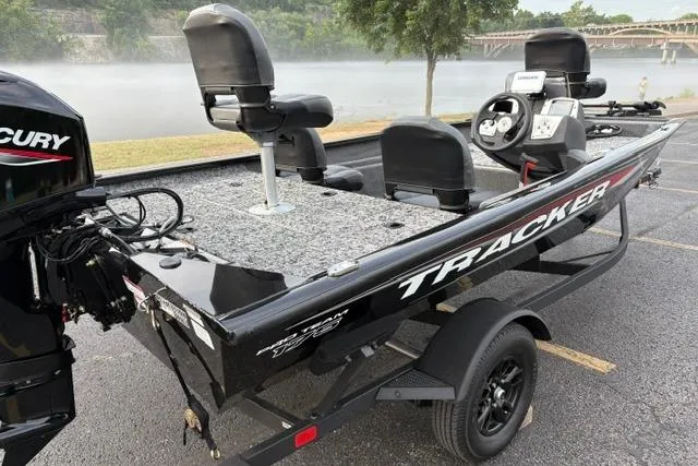 Slide: The Image of 2026 Tracker Pro Team 175 Crappie Edition boat on trailer by a misty lake. - 8
