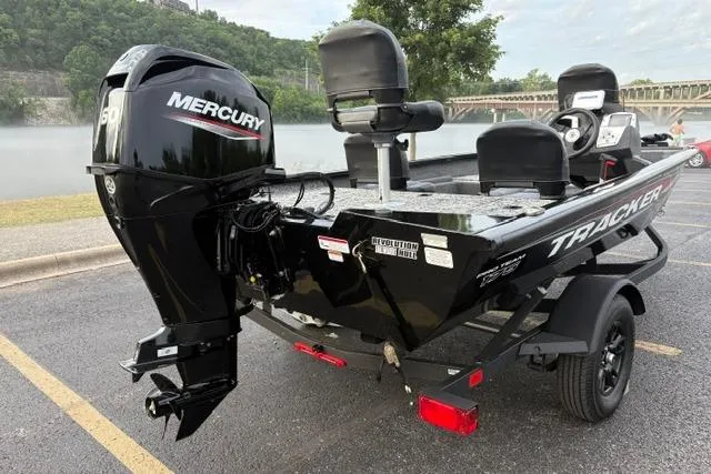 Slide: The Image of 2026 Tracker Pro Team 175 Crappie Edition boat with Mercury engine, parked near a scenic river. - 6