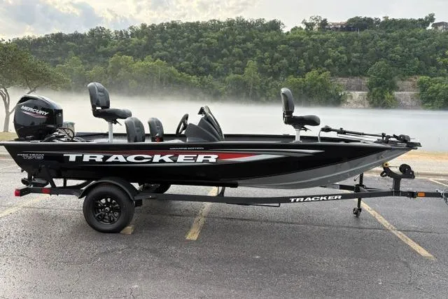 The Image of 2026 Tracker Pro Team 175 Crappie Edition boat on trailer, parked near misty lake. - 0