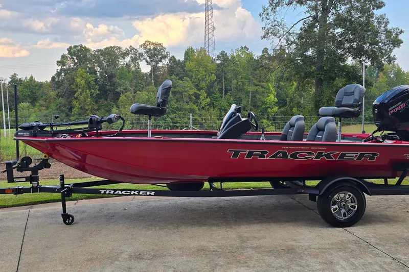 The Image of 2026 Tracker Pro Team 190 boat on trailer, red exterior, parked outdoors. - 0