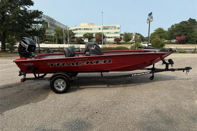 Slide: The Image of 2026 Tracker Pro Team 175 Crappie Edition boat in a parking lot, side view. - 5