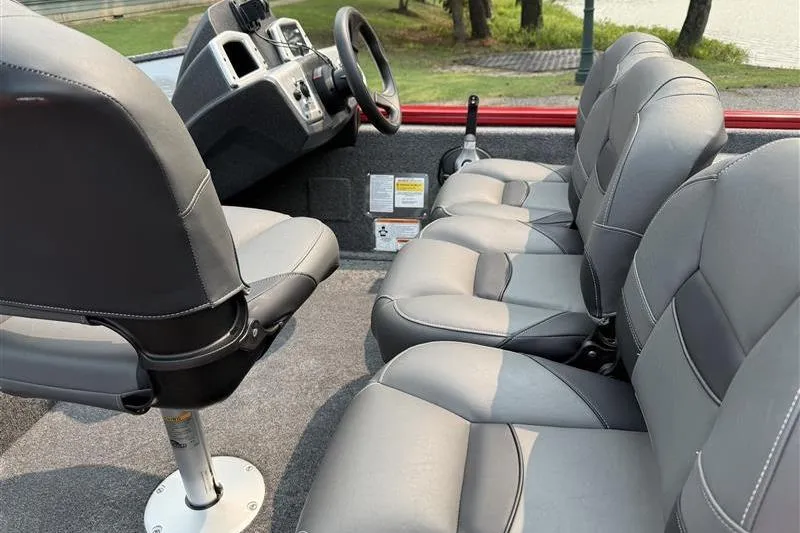 Slide: The Image of 2026 Tracker Pro Team 175 Crappie Edition boat interior with gray seating and steering console. - 9