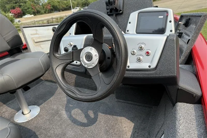 Slide: The Image of 2026 Tracker Pro Team 175 Crappie Edition boat interior with steering wheel and control panel. - 7