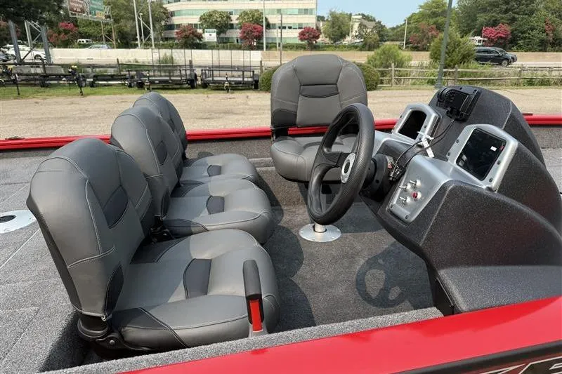 Slide: The Image of 2026 Tracker Pro Team 175 Crappie Edition boat interior with gray seating and steering console. - 8