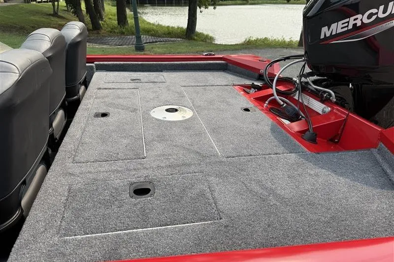 Slide: The Image of 2026 Tracker Pro Team 175 Crappie Edition boat deck with Mercury engine, near a lake. - 11