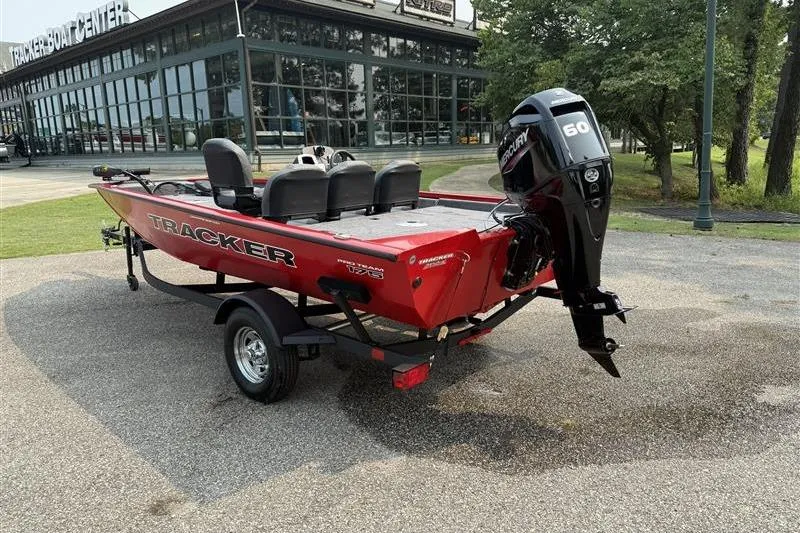 Slide: The Image of 2026 Tracker Pro Team 175 Crappie Edition boat with Mercury 60 engine, parked outside. - 2