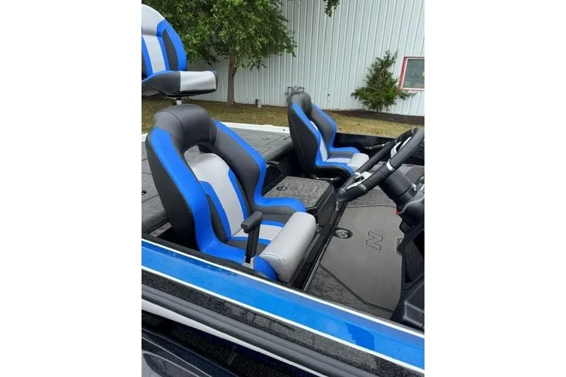 Slide: The Image of 2026 Nitro Z21 XL boat interior with blue and gray seats, steering wheel visible. - 9