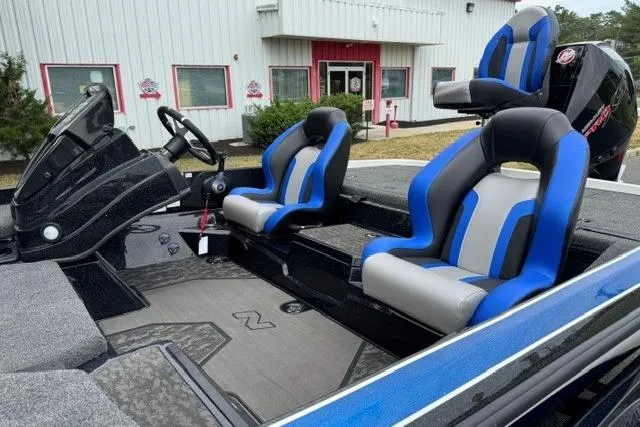 Slide: The Image of 2026 Nitro Z21 XL boat interior with blue and gray seats, steering wheel, and console. - 8