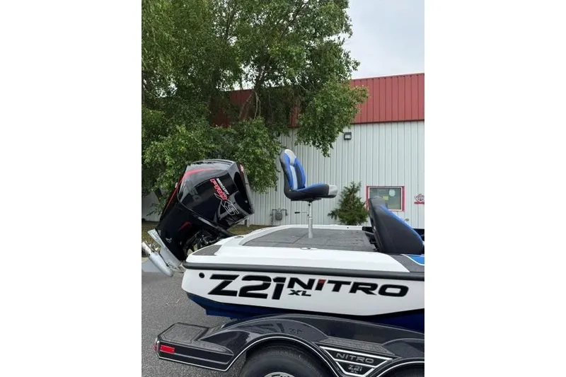 Slide: The Image of 2026 Nitro Z21 XL boat with blue seats and powerful outboard motor. - 12