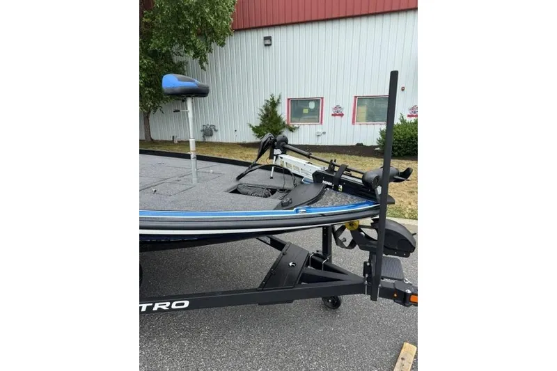 Slide: The Image of 2026 Nitro Z21 XL boat on trailer, parked outdoors near a building. - 6