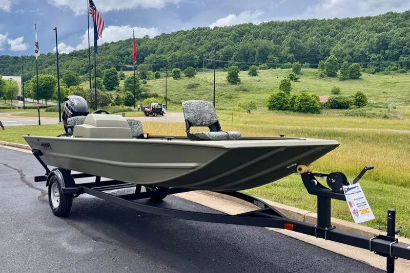 Slide: The Image of 2026 Tracker Grizzly 1754 SC boat on trailer, parked outdoors with scenic background. - 2