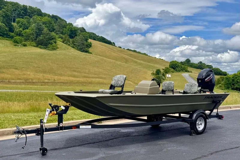 Slide: The Image of 2026 Tracker Grizzly 1754 SC boat on trailer, scenic countryside background. - 3
