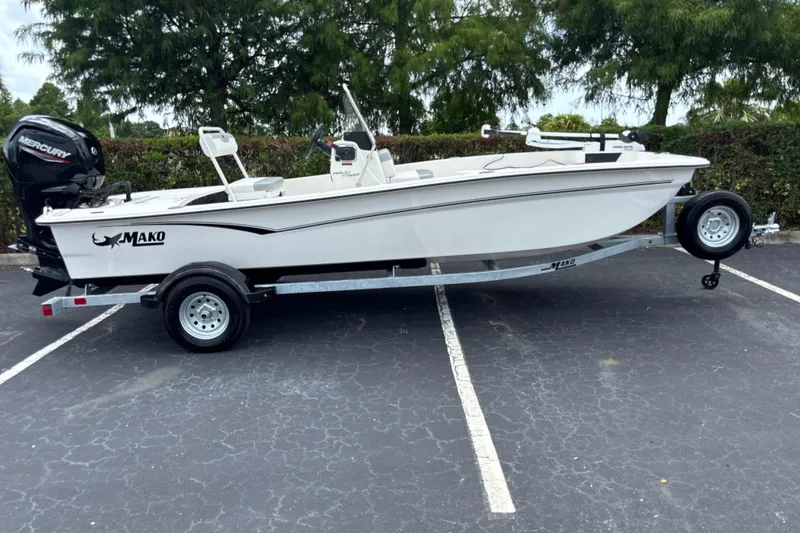 Slide: The Image of 2026 Mako Pro Skiff 17 CC boat on trailer, parked in a lot. - 1