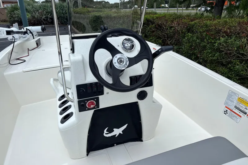 Slide: The Image of 2026 Mako Pro Skiff 17 CC boat console with steering wheel and control panel. - 6
