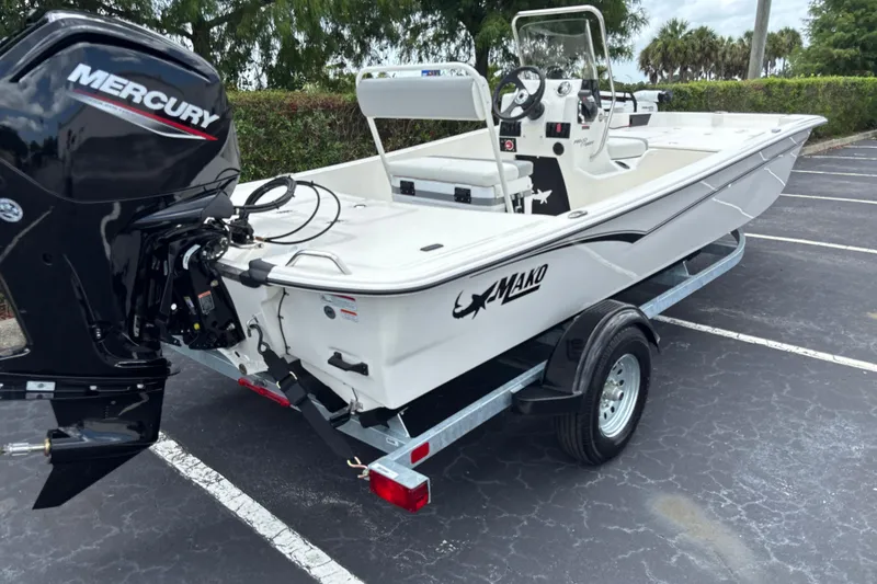 Slide: The Image of 2026 Mako Pro Skiff 17 CC boat with Mercury engine on trailer in parking lot. - 3