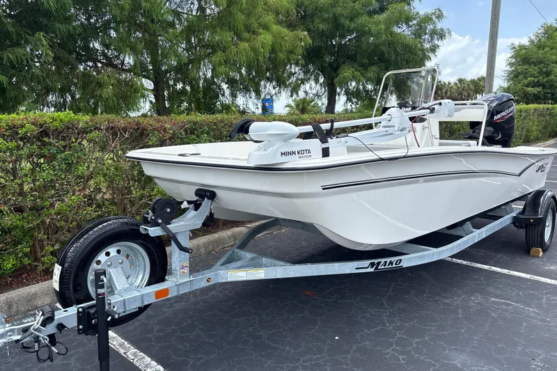 Slide: The Image of 2026 Mako Pro Skiff 17 CC boat on trailer, parked outdoors. - 2