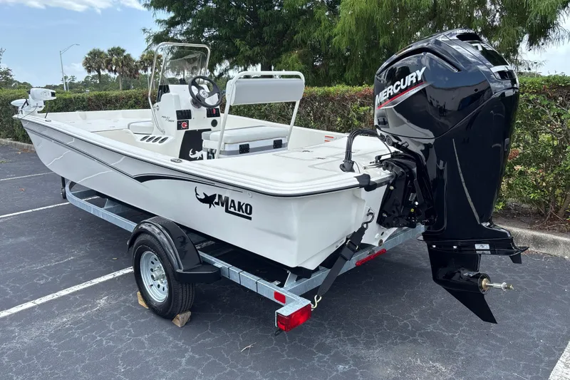 Slide: The Image of 2026 Mako Pro Skiff 17 CC boat with Mercury outboard motor on trailer. - 5