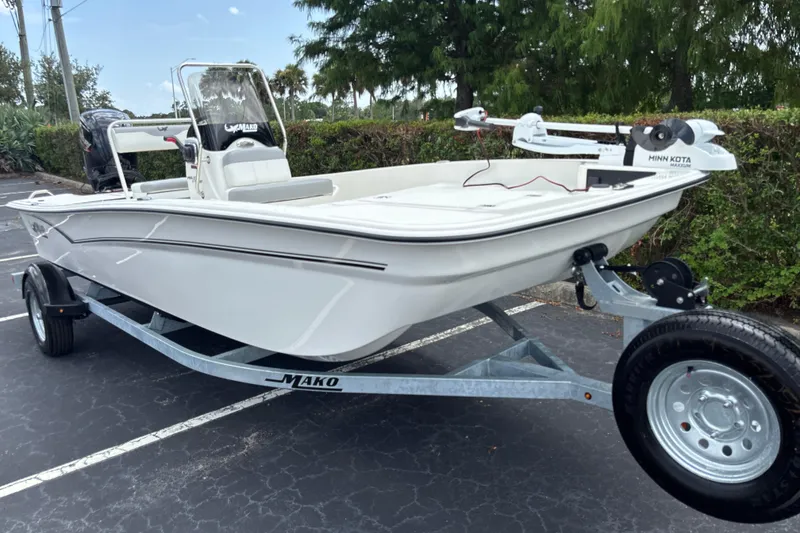 Slide: The Image of 2026 Mako Pro Skiff 17 CC boat on trailer, featuring Minn Kota trolling motor. - 4