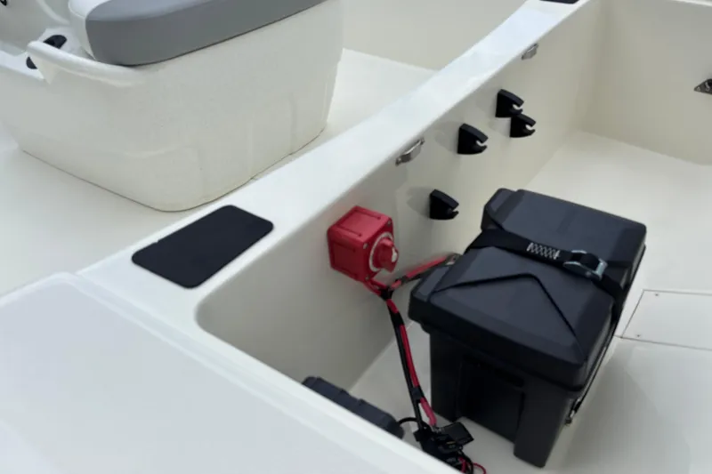 Slide: The Image of Interior of 2026 Mako Pro Skiff 17 CC boat showing storage and battery compartment. - 9