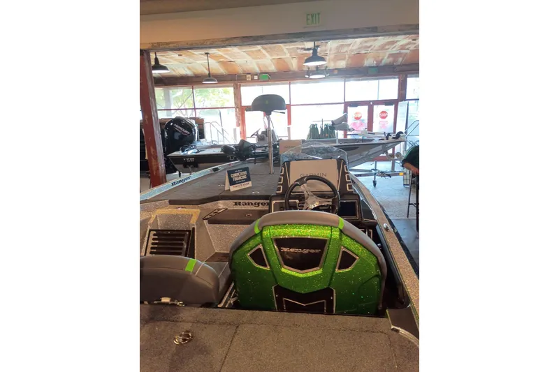 Slide: The Image of 2026 Ranger Z519R Cup-Equipped boat with green accents displayed indoors. - 4