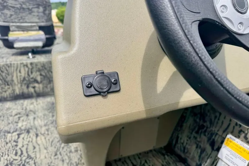 Slide: The Image of Dashboard of 2026 Tracker Grizzly 1754 SC boat with steering wheel and accessory port. - 11
