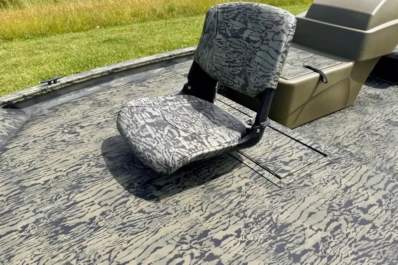 Slide: The Image of 2026 Tracker Grizzly 1754 SC boat seat with camouflage pattern on deck. - 8
