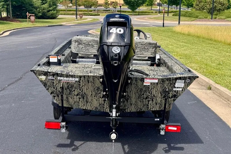 Slide: The Image of 2026 Tracker Grizzly 1754 SC boat with camo design and Mercury 40 engine. - 4