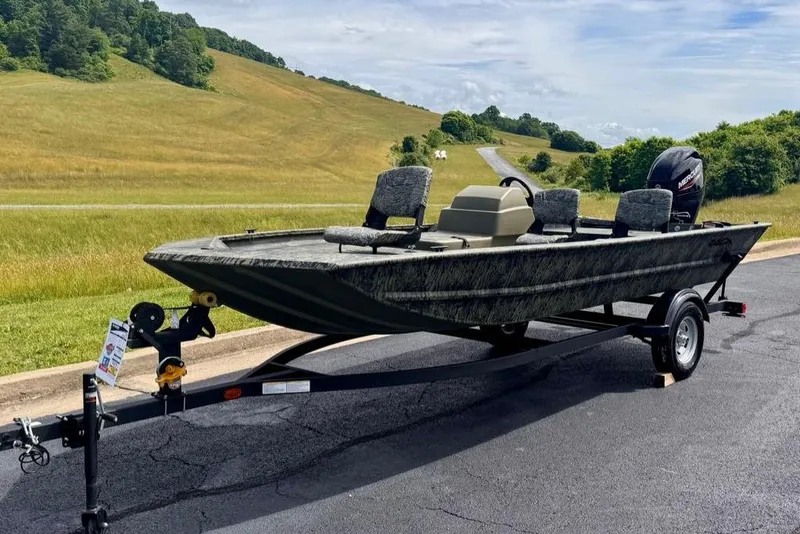 Slide: The Image of 2026 Tracker Grizzly 1754 SC boat on trailer, scenic countryside background. - 3