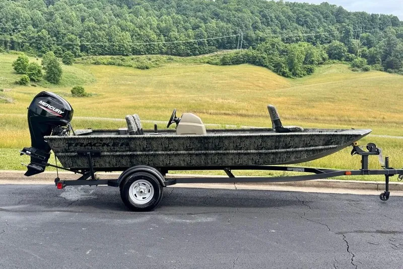 The Image of 2026 Tracker Grizzly 1754 SC boat on trailer, scenic countryside background. - 0