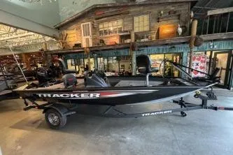 The Image of 2026 Tracker Pro Team 175 Crappie Edition boat displayed indoors, showcasing sleek design. - 0