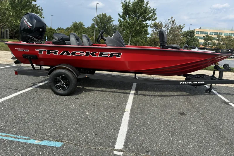 Slide: The Image of Red 2026 Tracker Pro Team 195 boat on trailer in parking lot. - 78