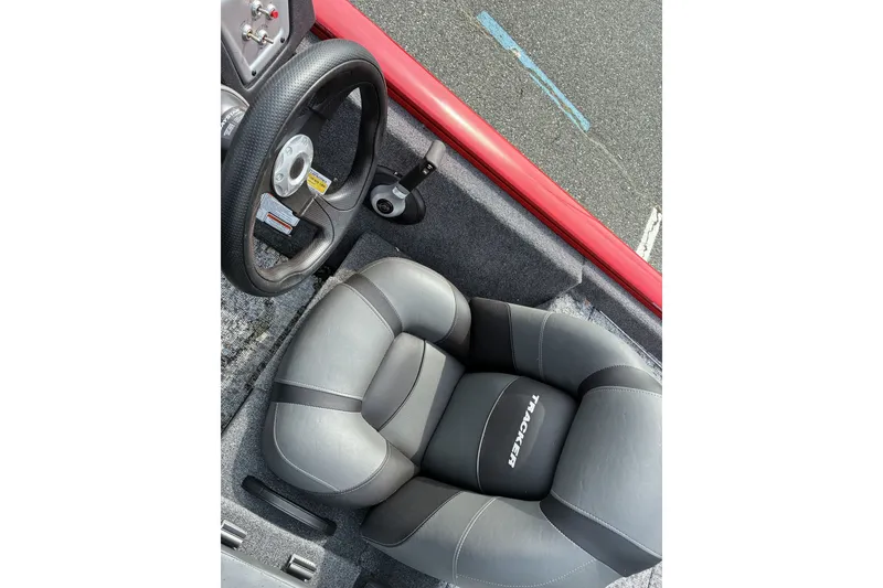 Slide: The Image of 2026 Tracker Pro Team 195 boat interior with steering wheel and cushioned seat. - 15