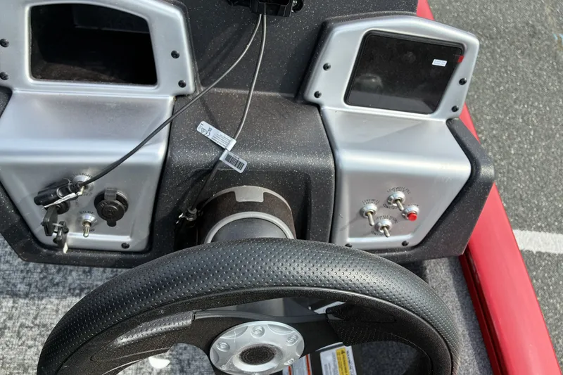 Slide: The Image of Steering console of 2026 Tracker Pro Team 195 boat with controls and switches. - 13