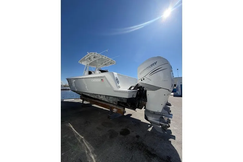 The Image of 2021 Contender boat with Mercury outboard engine under clear blue sky. - 1